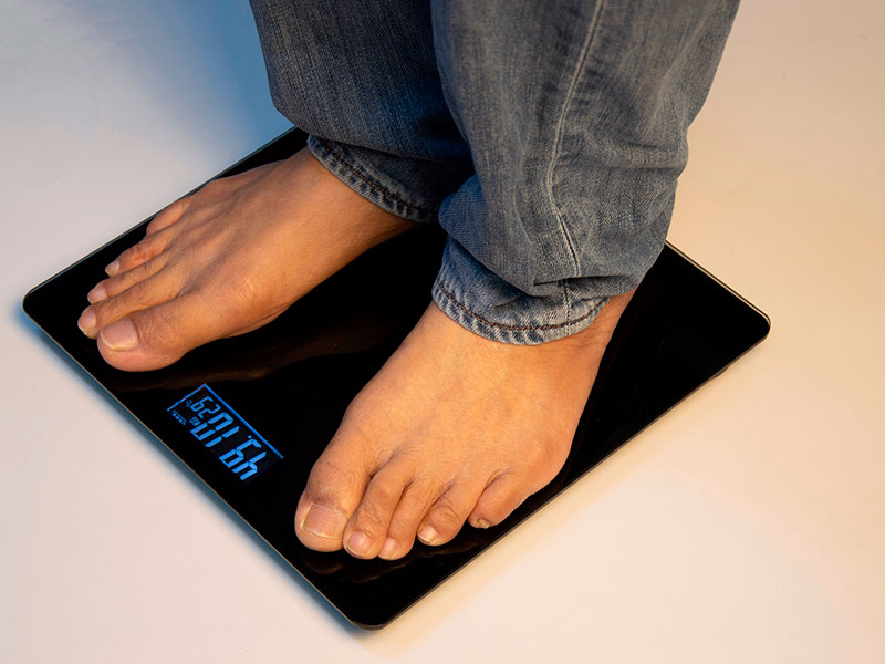 man's feet on the scales