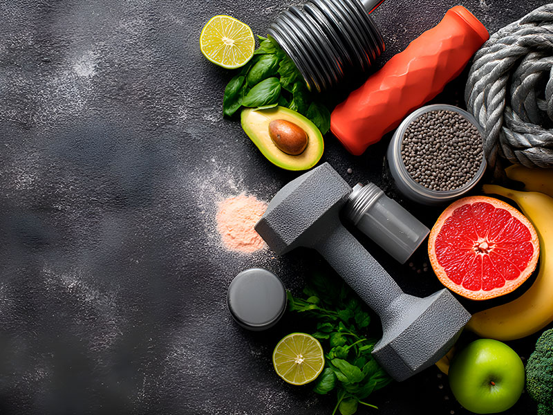 Fitness and healthy food promoting active lifestyle with dumbbells and fresh produce