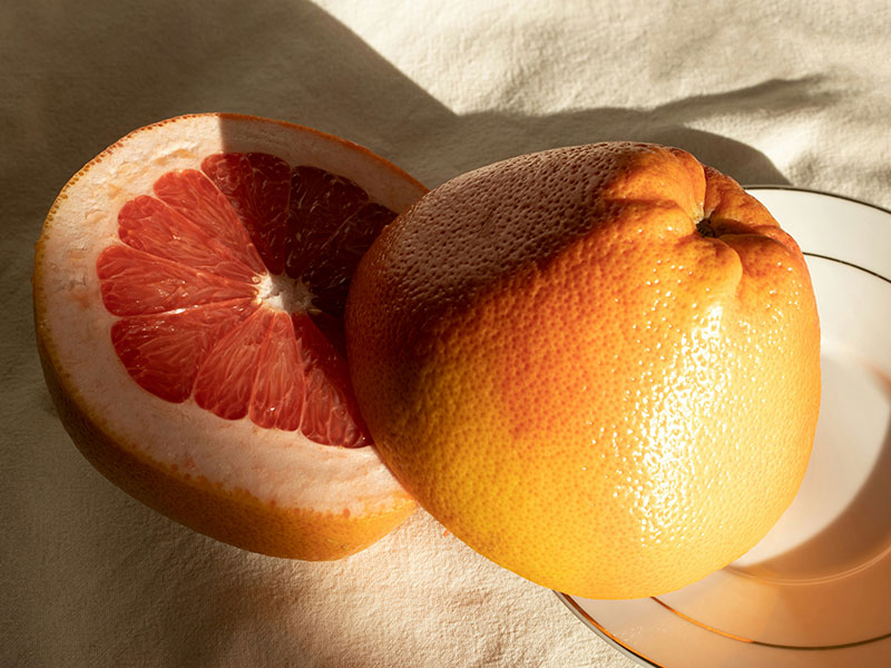 The grapefruit is on the plate.