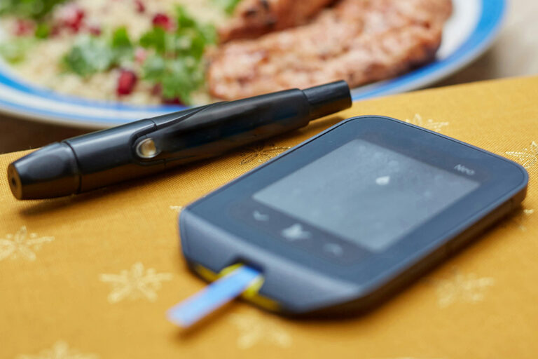 devices and medicines for the treatment of diabetes and blood sugar measurement and the food is on a plate on the table