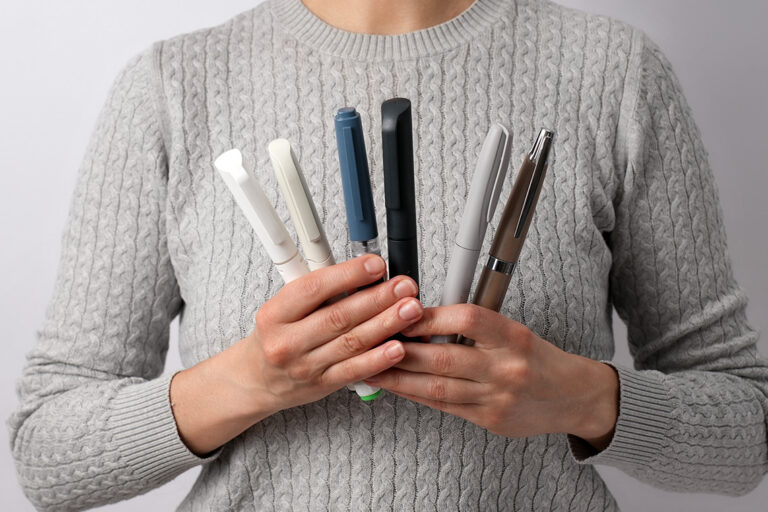 a girl holds various drugs for the treatment of diabetes in her hands
