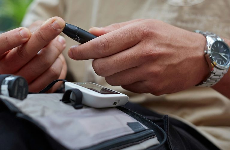 a man checks his blood sugar levels