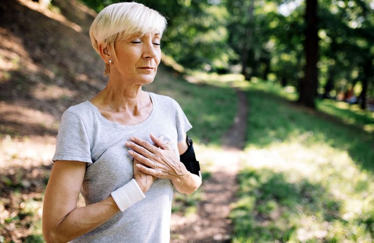Woman with chest pain suffering from heart attack during running