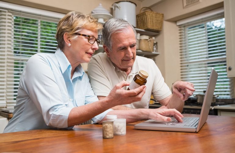 Senior couple looking up medication online