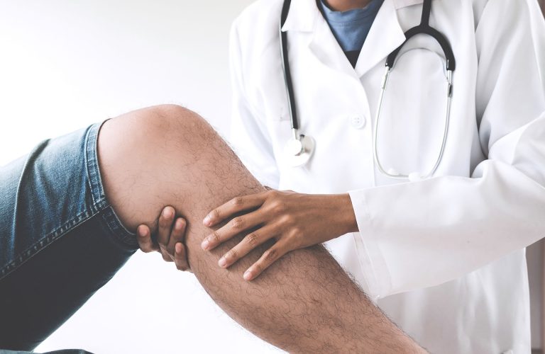 Doctor checking patient with knees to determine the cause of illness.